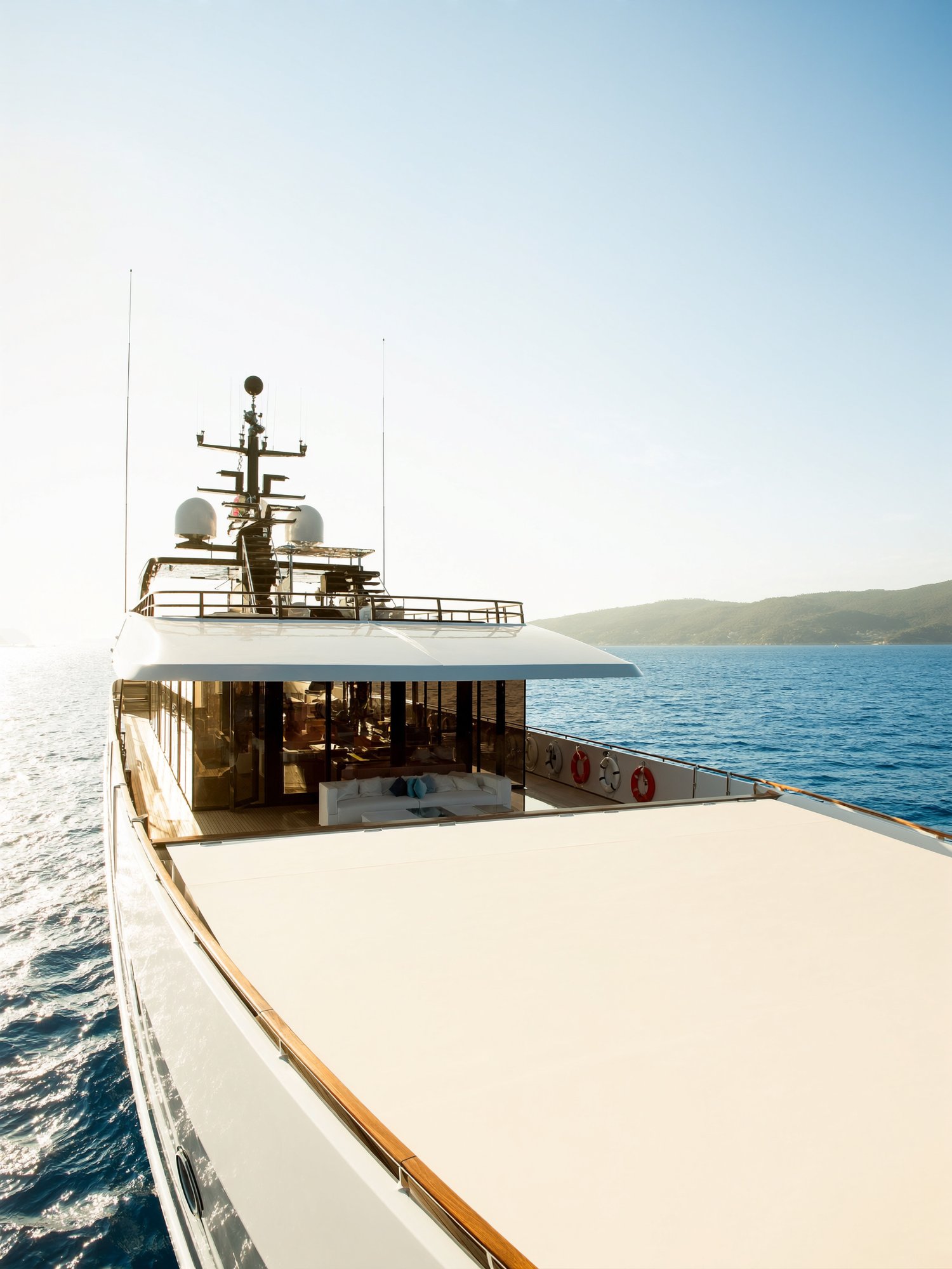 Luxury superyacht at midday over turquoise water