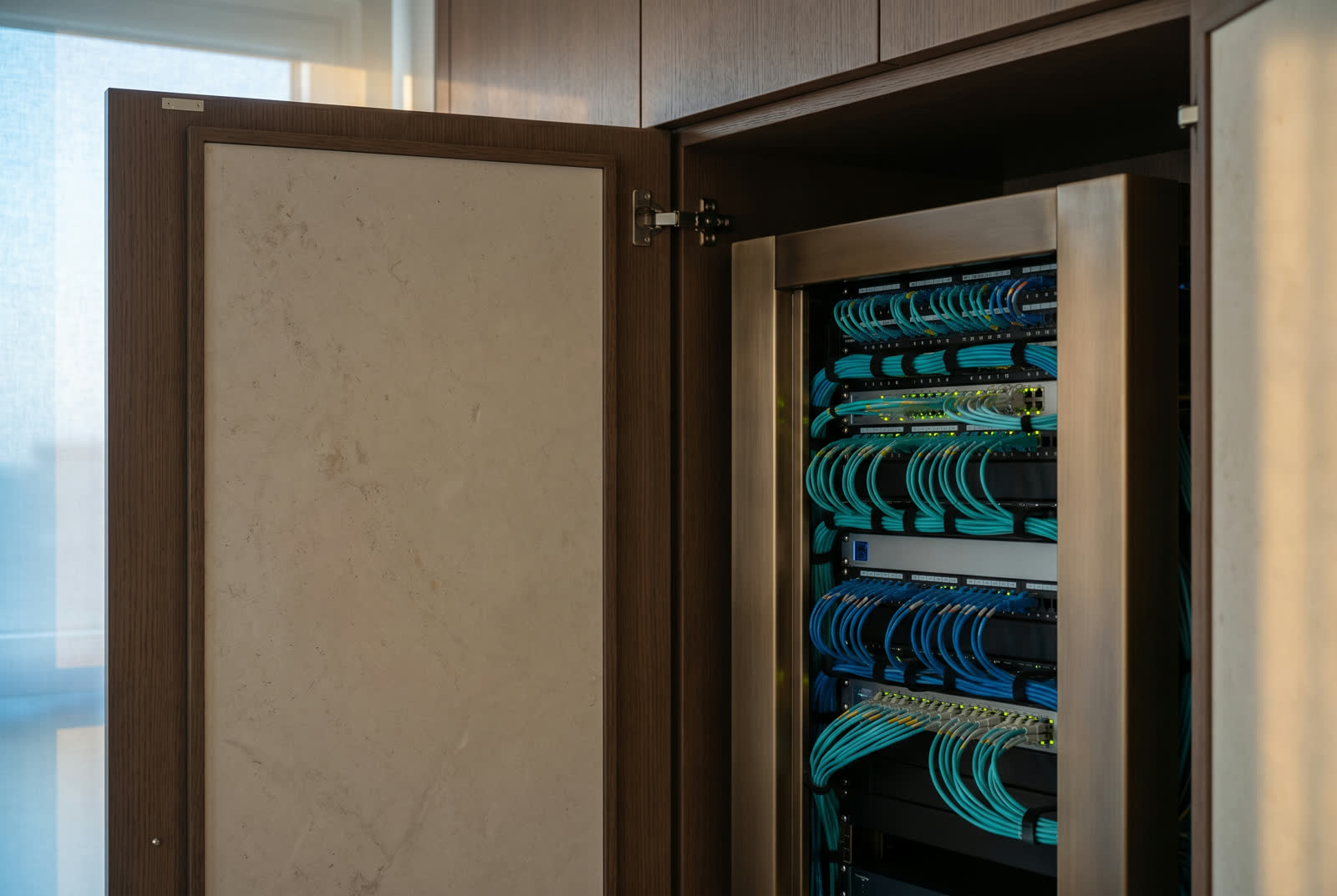 Architectural rack room with fiber, ethernet, and color-coded labels